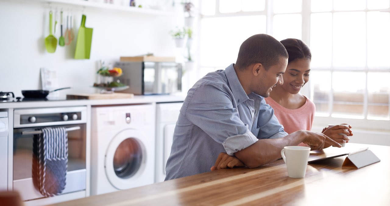 hero cover section, couple using a table to control their home