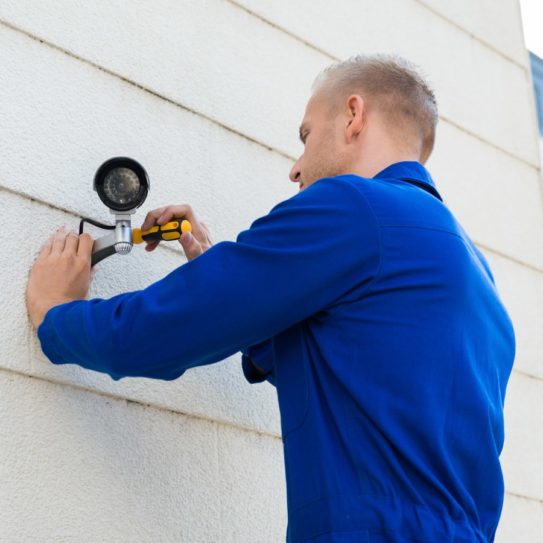 technician installing security cameras